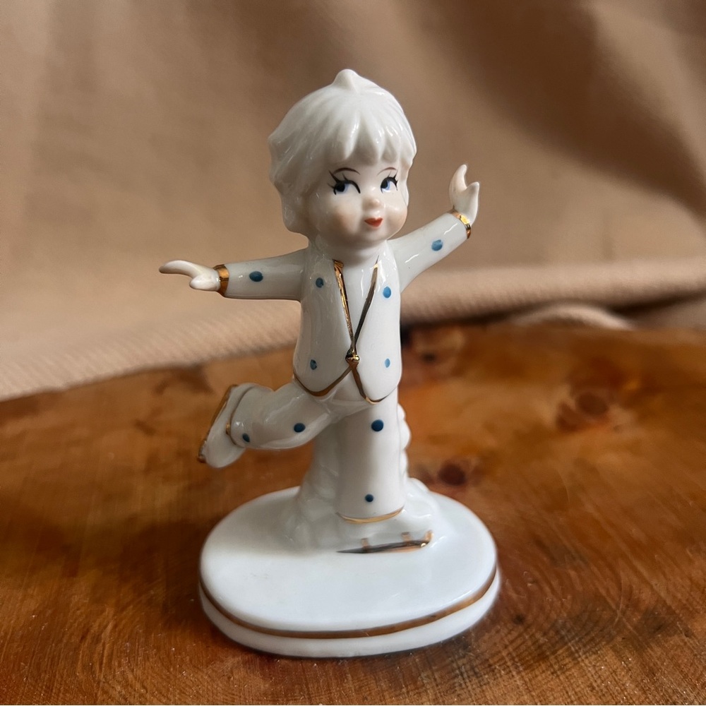 Vintage Porelain girl figurine figuring skating with gold accents.
